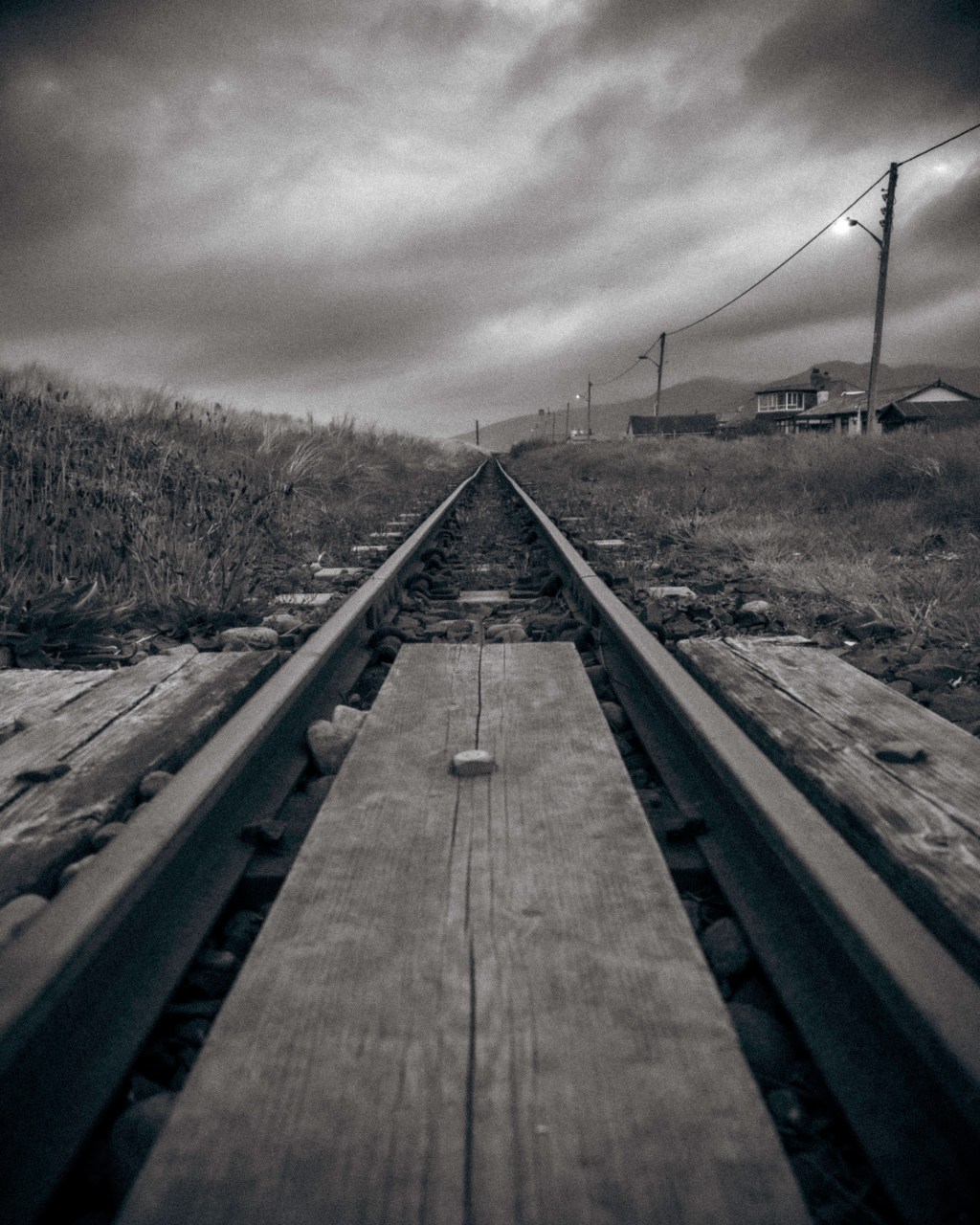 My photograph of the tracks running into the distance in the Blue Hour with moody skies - Fairbourne Railway in Eryri National Park